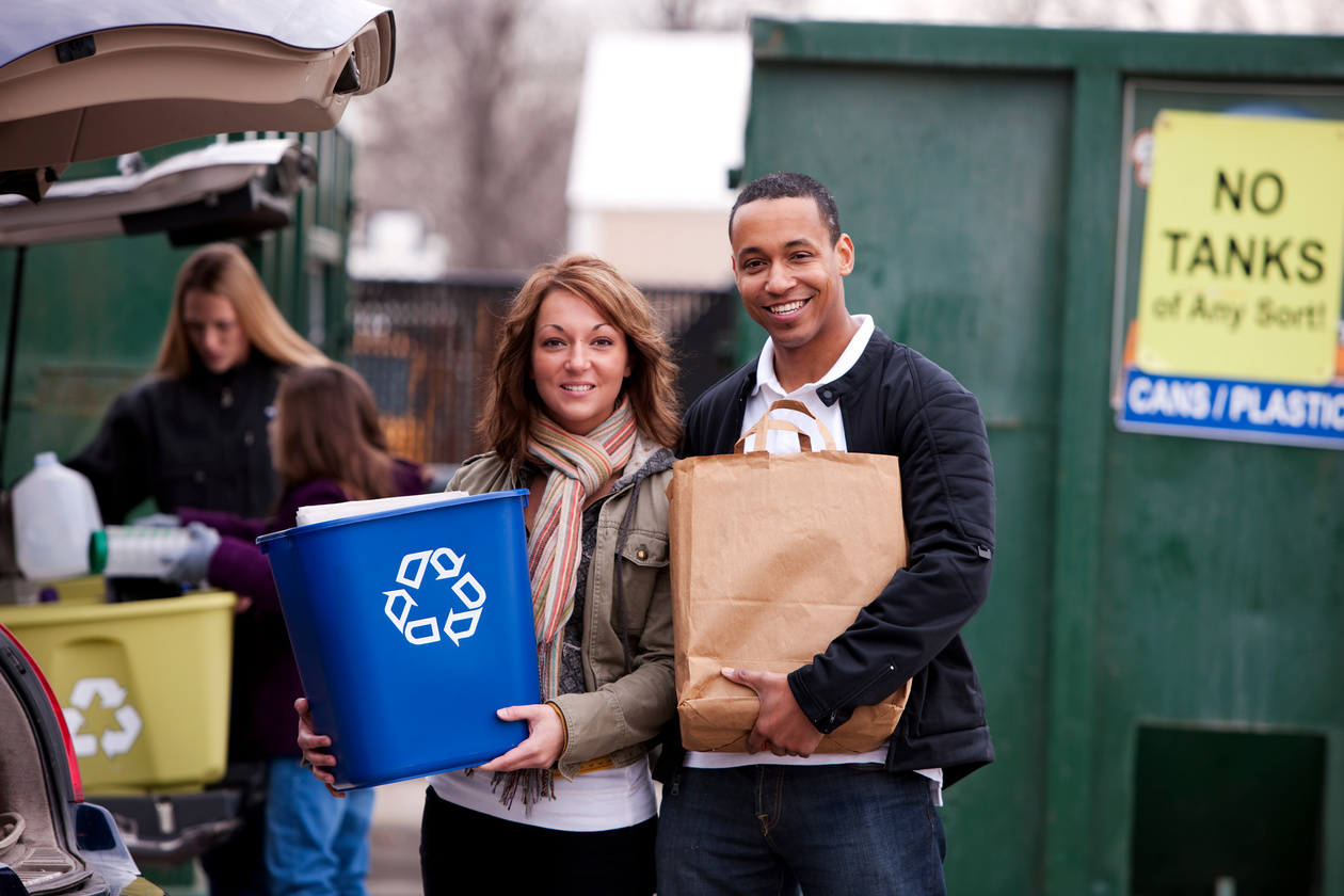 Interracial Couple Brings Trash to Recycling Center